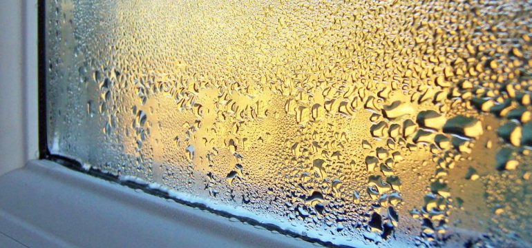 heavy-condensation-on-glass-and-wooden-window-frame