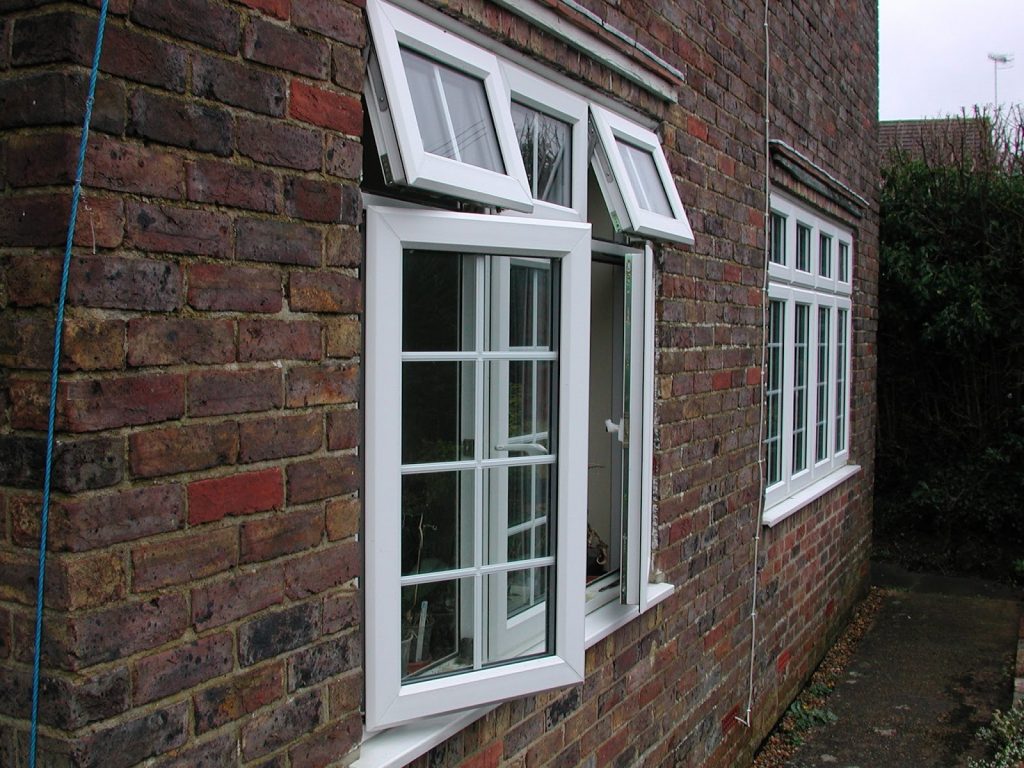 Face brick side view of a house with white painted windows