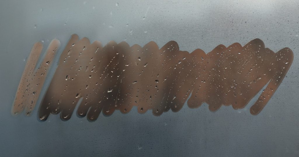 property-care-condensation-smeared-on-window-close-up